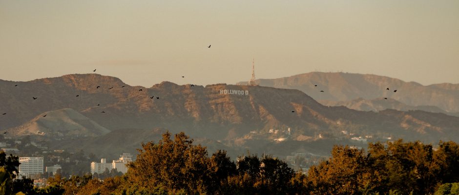 Dramatic sunset view capturing the iconic Hollywood sign against a scenic hill backdrop.
